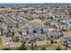 A wide aerial perspective of homes in a planned community, showing street layout and surrounding amenities at 9694 Dunning Cir, Highlands Ranch, CO 80126