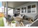 Cozy covered back patio with ample seating, a grill, and sliding glass doors for indoor/outdoor living at 9694 Dunning Cir, Highlands Ranch, CO 80126
