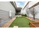 Low-maintenance backyard with artificial turf, landscaping, and a covered patio with outdoor seating at 9694 Dunning Cir, Highlands Ranch, CO 80126