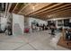 Unfinished basement with exposed beams, concrete floor and partial drywall at 9694 Dunning Cir, Highlands Ranch, CO 80126