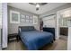 Stylish bedroom featuring a blue bedspread, plantation shutters, and en-suite bath at 9694 Dunning Cir, Highlands Ranch, CO 80126