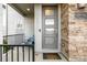 Inviting front porch with a modern door and stacked stone accents at 9694 Dunning Cir, Highlands Ranch, CO 80126