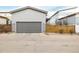 Two car garage with driveway and street parking at 9694 Dunning Cir, Highlands Ranch, CO 80126