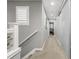 Carpeted upstairs hallway with natural light and minimalist aesthetic at 9694 Dunning Cir, Highlands Ranch, CO 80126