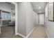 Hallway leading to a bedroom, featuring neutral carpet and sliding closet doors at 9694 Dunning Cir, Highlands Ranch, CO 80126