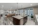 Open kitchen with granite island, stainless appliances, and sliding door to the patio at 9694 Dunning Cir, Highlands Ranch, CO 80126