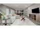 Open concept living area flowing into the dining room with modern finishes at 9694 Dunning Cir, Highlands Ranch, CO 80126