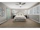 Spacious main bedroom with neutral decor, plantation shutters, and ceiling fan at 9694 Dunning Cir, Highlands Ranch, CO 80126