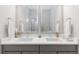 Modern bathroom featuring double vanity, ample lighting, and contemporary fixtures at 4781 Saddle Iron Rd, Castle Rock, CO 80104