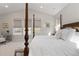 Bright primary bedroom featuring four-poster bed, and views through three windows at 4781 Saddle Iron Rd, Castle Rock, CO 80104