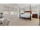 Spacious primary bedroom with many windows, neutral colors, and decorative furniture at 4781 Saddle Iron Rd, Castle Rock, CO 80104
