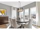 Open dining room featuring an elegant light fixture and large windows at 4781 Saddle Iron Rd, Castle Rock, CO 80104