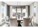 Spacious dining room featuring an elegant light fixture and large windows at 4781 Saddle Iron Rd, Castle Rock, CO 80104