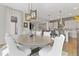 Open dining room and kitchen featuring an elegant light fixture and breakfast bar at 4781 Saddle Iron Rd, Castle Rock, CO 80104