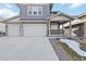 Charming two-story home with a spacious three-car garage and inviting front porch, perfect for enjoying the neighborhood views at 4781 Saddle Iron Rd, Castle Rock, CO 80104