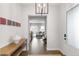 Bright foyer showcasing hardwood floors, modern light fixture, and a glimpse into the open-concept living space at 4781 Saddle Iron Rd, Castle Rock, CO 80104