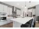 Modern kitchen featuring stainless steel appliances, a large center island with seating, and sleek countertops at 4781 Saddle Iron Rd, Castle Rock, CO 80104