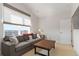 Comfortable living room with large window, sectional sofa, and cozy furnishings at 4781 Saddle Iron Rd, Castle Rock, CO 80104