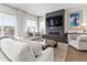 Bright living room featuring a contemporary fireplace, stylish decor, and large windows offering picturesque views at 4781 Saddle Iron Rd, Castle Rock, CO 80104
