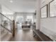 Elegant living room featuring hardwood floors, plush seating, and abundant natural light streaming through large windows at 4781 Saddle Iron Rd, Castle Rock, CO 80104