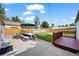 Large backyard with a concrete patio, wooden deck, and green grass at 5570 Otis Ct, Arvada, CO 80002