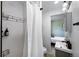 Modern bathroom with subway tile shower and sleek fixtures with view to bedroom at 5570 Otis Ct, Arvada, CO 80002