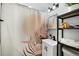 Stylish bathroom with modern vanity, decorative shower curtain, and shelving for storage at 5570 Otis Ct, Arvada, CO 80002