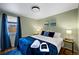A well-lit bedroom with a comfortable bed, stylish decor, and calming ambiance at 5570 Otis Ct, Arvada, CO 80002