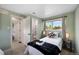 A cozy bedroom features a comfortable bed, natural light, and a calming color scheme at 5570 Otis Ct, Arvada, CO 80002