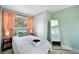 Inviting bedroom with soft green walls, plush carpeting, and ample natural light at 5570 Otis Ct, Arvada, CO 80002