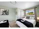 A bright bedroom features a comfortable bed and a view of the outdoors at 5570 Otis Ct, Arvada, CO 80002