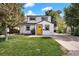 Charming home with a well-manicured lawn and a bright yellow front door at 5570 Otis Ct, Arvada, CO 80002