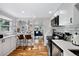 Bright kitchen with white cabinets, stainless steel appliances, and a breakfast bar at 5570 Otis Ct, Arvada, CO 80002