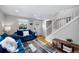 Cozy living room with hardwood floors and an open staircase with white risers at 5570 Otis Ct, Arvada, CO 80002