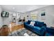 Bright living room featuring a comfortable blue sofa, hardwood floors, and modern decor at 5570 Otis Ct, Arvada, CO 80002