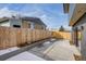 Backyard view showcasing the concrete patio and wooden fence at 1459 W 42Nd Ave, Denver, CO 80211