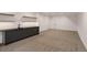 Spacious finished basement with wet bar, shelving, and neutral carpet at 1459 W 42Nd Ave, Denver, CO 80211