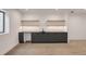 Finished basement with wet bar area, featuring sleek dark cabinets and floating shelves at 1459 W 42Nd Ave, Denver, CO 80211