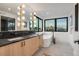 Luxurious bathroom with double vanity, modern fixtures, and freestanding tub by large windows at 1459 W 42Nd Ave, Denver, CO 80211