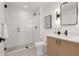 Stylish bathroom boasts a glass-enclosed shower, wood vanity and black accents for a contemporary feel at 1459 W 42Nd Ave, Denver, CO 80211