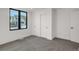 Bedroom with white walls, gray carpet, large window, and closet with white sliding doors at 1459 W 42Nd Ave, Denver, CO 80211