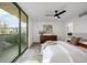 Sunlit bedroom with balcony access and a modern ceiling fan at 1459 W 42Nd Ave, Denver, CO 80211