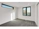 Bright bedroom featuring gray carpet, white walls, and a large window overlooking the neighborhood at 1459 W 42Nd Ave, Denver, CO 80211