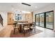 Open concept dining area with modern kitchen, hardwood floors, and access to the backyard at 1459 W 42Nd Ave, Denver, CO 80211