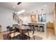 Dining area connecting to a modern kitchen with island seating and stylish light fixtures at 1459 W 42Nd Ave, Denver, CO 80211