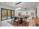 Open dining area with modern lighting and sliding glass doors to the backyard patio at 1459 W 42Nd Ave, Denver, CO 80211