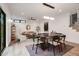 Open concept dining room featuring modern light fixtures and stylish furniture at 1459 W 42Nd Ave, Denver, CO 80211