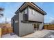Contemporary two-story home with gray siding, large windows, and a well-maintained backyard at 1459 W 42Nd Ave, Denver, CO 80211