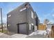 Modern home featuring a gray exterior, a private entrance, and a garage at 1459 W 42Nd Ave, Denver, CO 80211