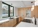 Modern kitchen with sleek cabinetry, quartz countertops, and a large window providing ample natural light at 1459 W 42Nd Ave, Denver, CO 80211
